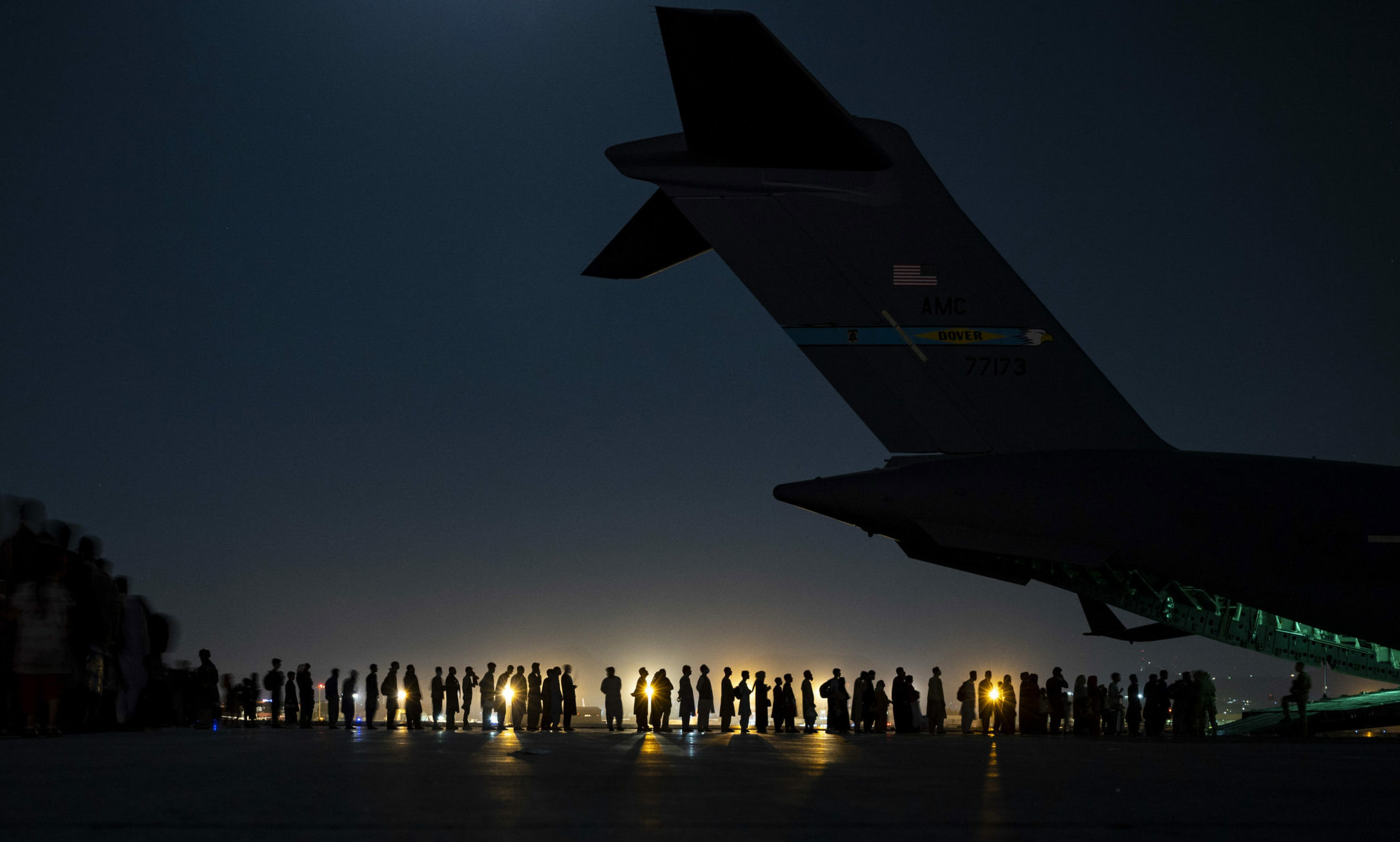 Evacuees from Afganistan boarding military plane at night
