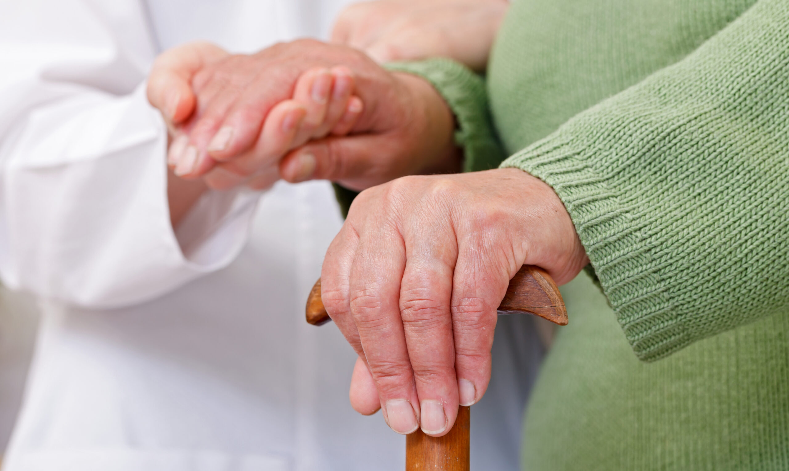 hands of nursing assistant and elderly resident