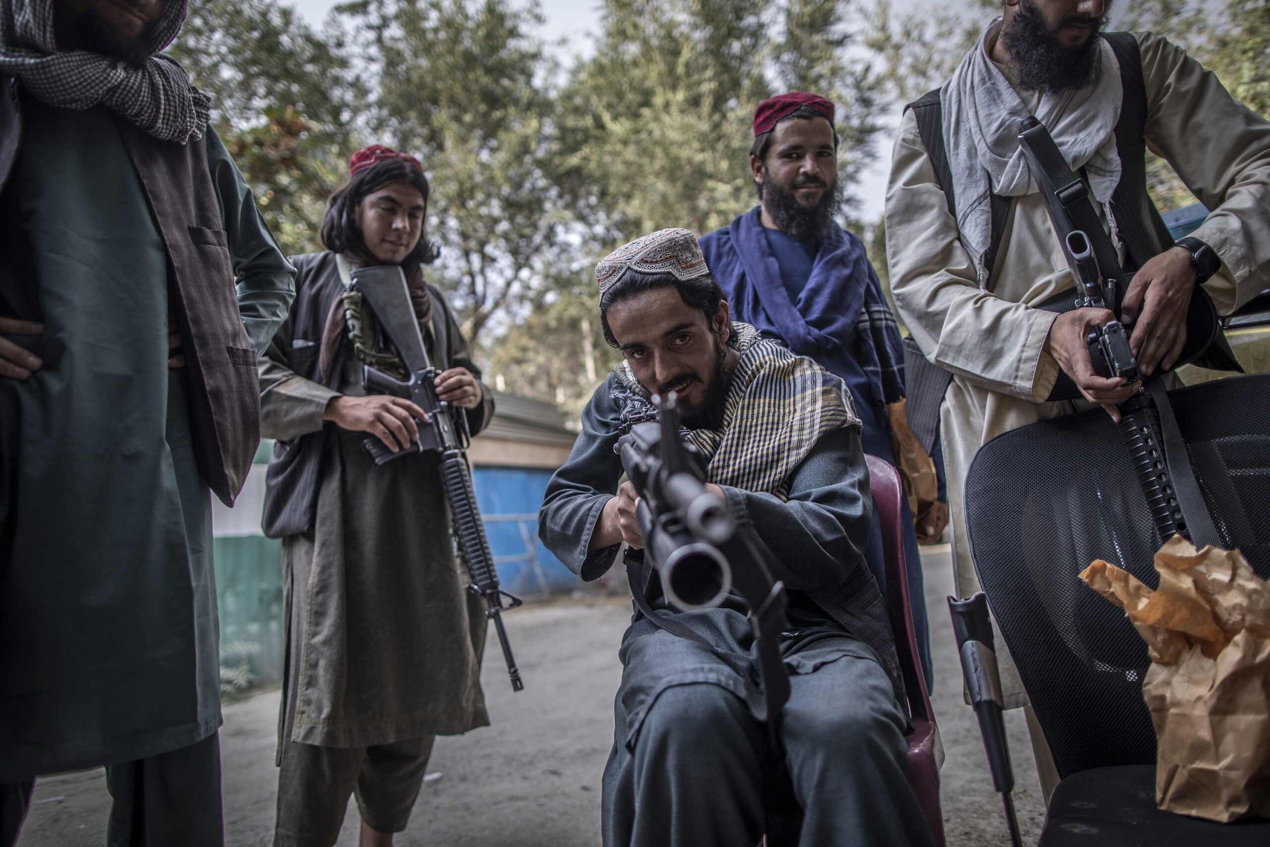taliban fighter pointing gun at camera