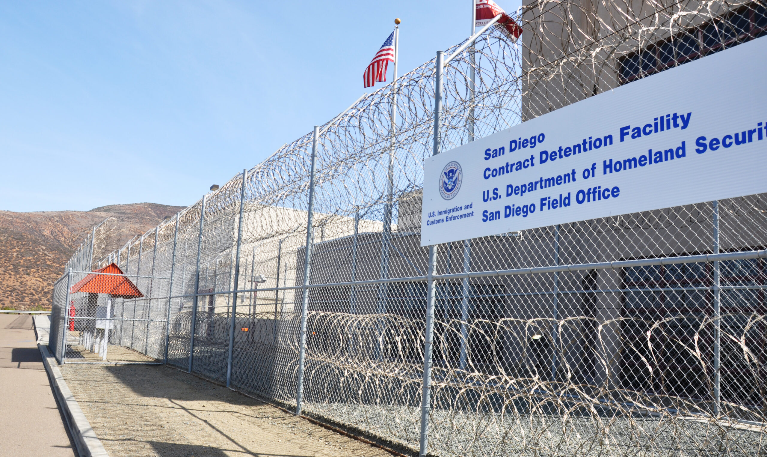 federal detention center fence with barbed wire